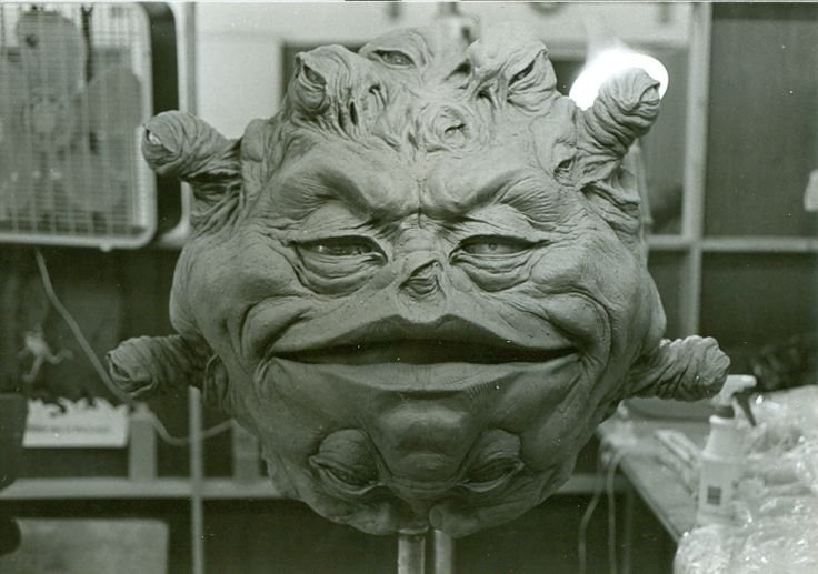 Prop of a floating head; it has a grimaced wrinkly face surrounded by many small eye balls