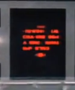 R2-D2 Responds: a close up of the X-wing console showing blurry red writing on a black background